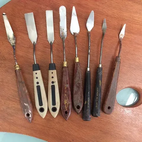 collection of palette knives on a wooden palette