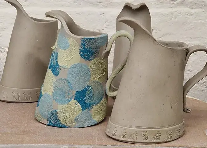 Juli Bharucha clay workshop three folded jugs with slip decoration in blue circles