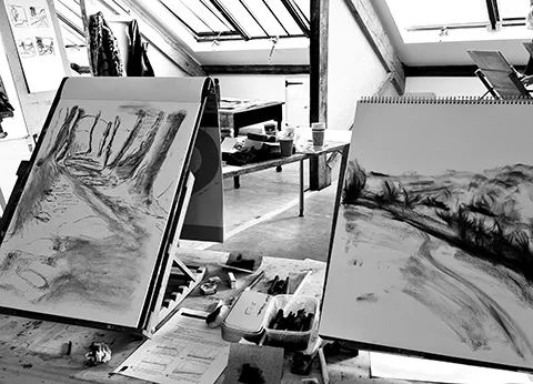 students charcoal landscapes on tabletop easels in studio