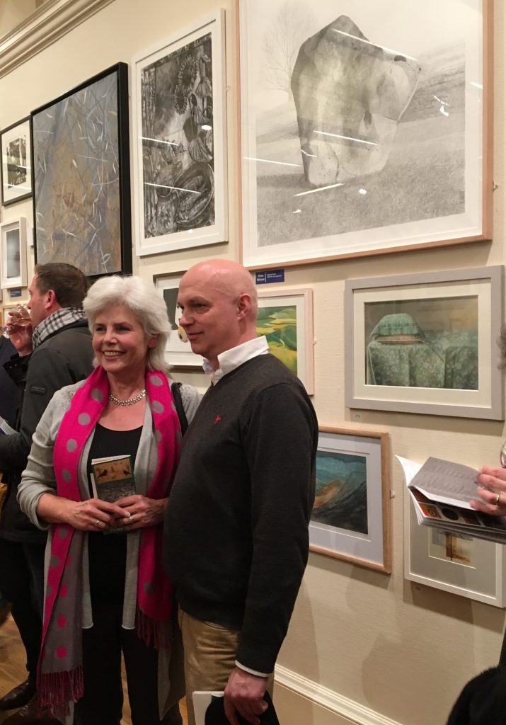 Jane Fisher (Director of Pegasus Art) and Andrew Lansley standing infront of artwork