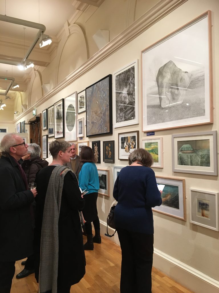 Visitor viewing artwork displayed at Bath Society of Artists Open Exhibition