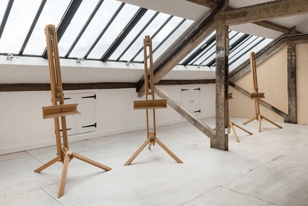 empty easels in large bright studio space under window