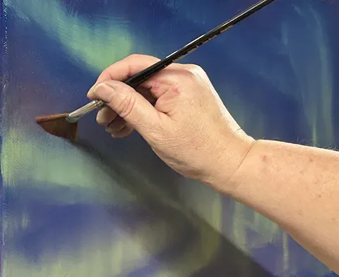 David Johnson workshop - lady's hand painting aurora with fan brush
