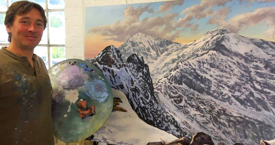 David Johnson DJ - stood with palette near large mountain painting