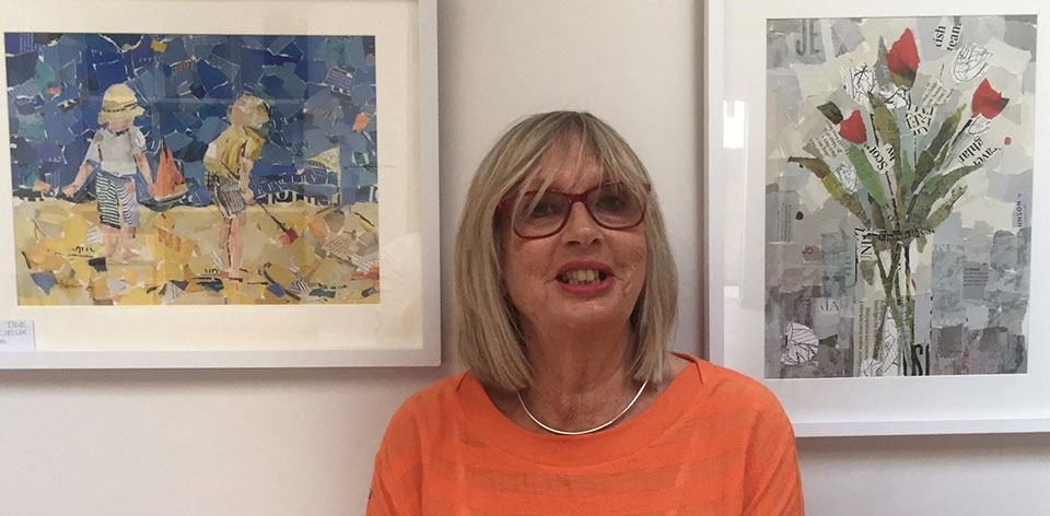 helen norman stood in front of framed collage pictures