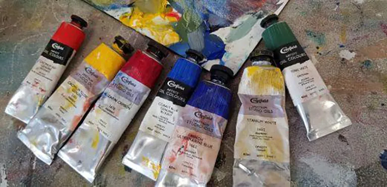 selection of used oil paint tubes and palette