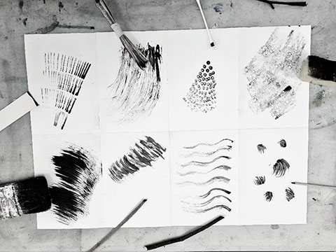 selection of different mark-making tools and techniques on paper